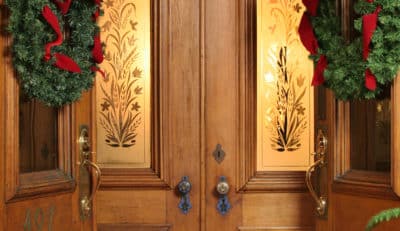 Front door of Saratoga Arms hotel with holiday wreaths