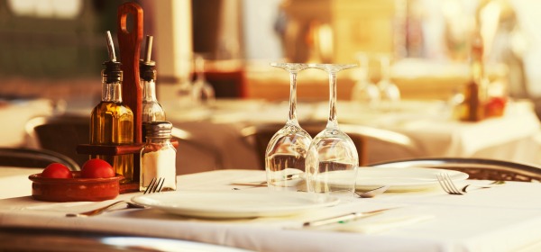 Empty outdoor restaurant table at sunset