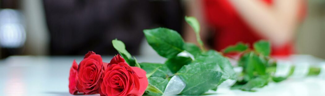 Red roses sit on table