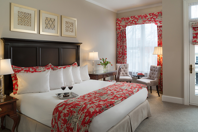 Beautiful hotel room with warm colors and wine on a tray