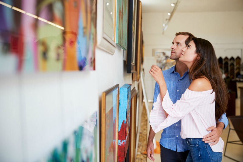 Couple looking at art paintings