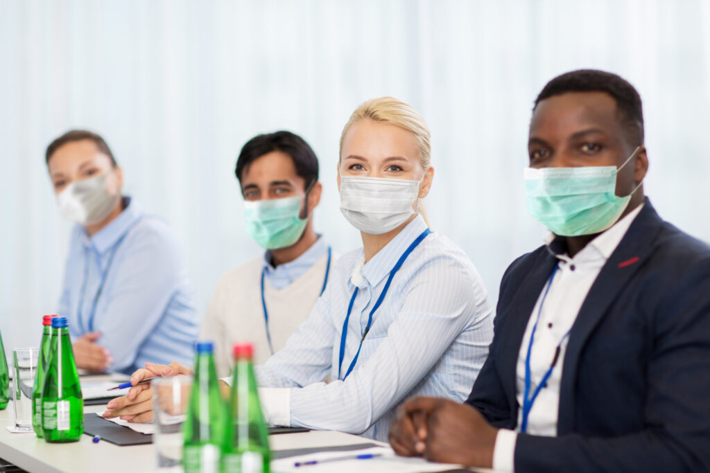 4 people in a meeting wearing masks