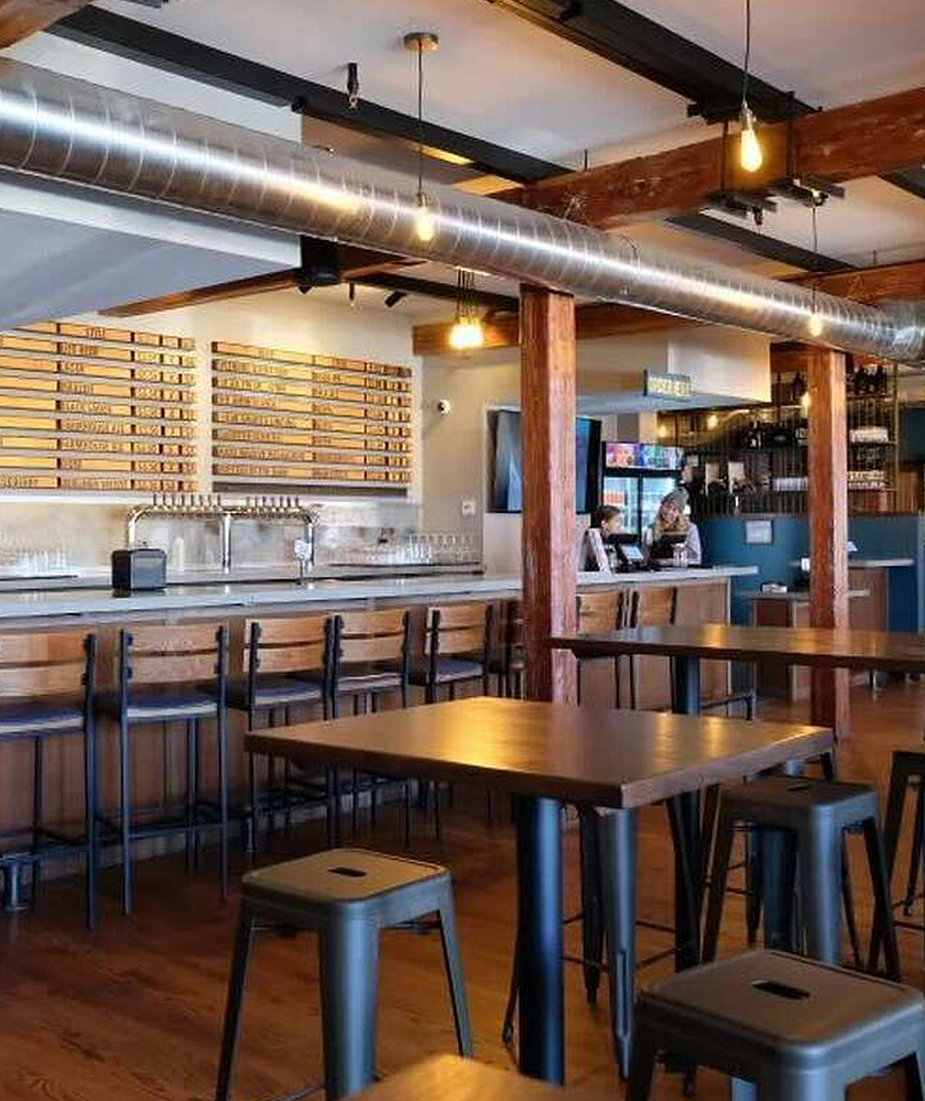 Interior of a new rustic brewery with a large selection of craft beer made on site.