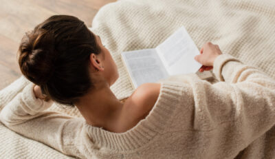 woman reading a book in bed